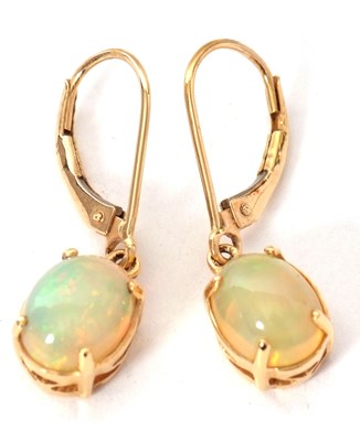 Lot 101 - A pair of 18K opal earrings, the oval claw...