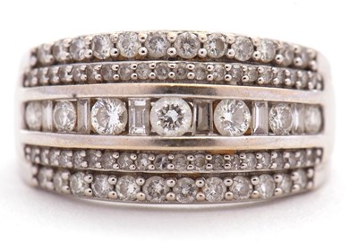 Lot 74 - An 18ct diamond ring, set with a central...