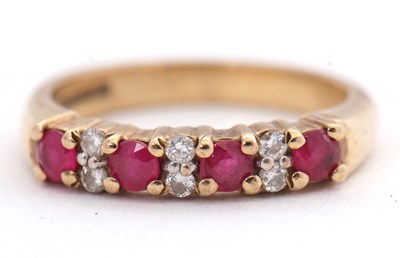 Lot 22 - A 9ct ruby and diamond ring, the four round...