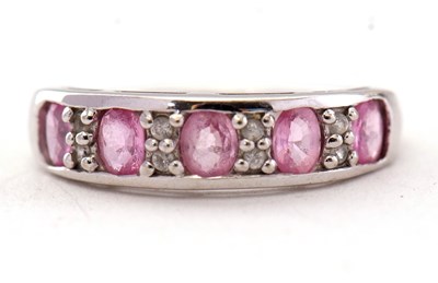 Lot 30 - A 9ct pink sapphire and white stone ring, the...