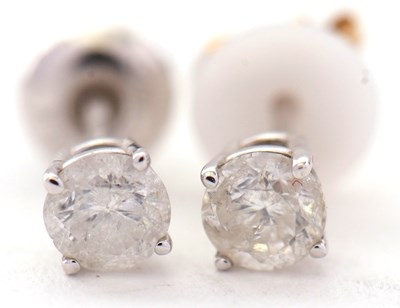 Lot 105 - A pair of diamond earstuds, each approx....