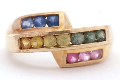 Lot 27 - A 9ct multi gemset ring, the crossover style...