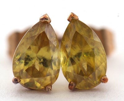Lot 113 - A pair of gemset earrings, the pear shape...