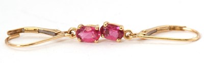 Lot 99 - A pair of 18K rubelite earrings, the oval...