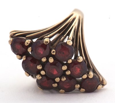 Lot 63 - A 9ct garnet cluster ring, set with round...