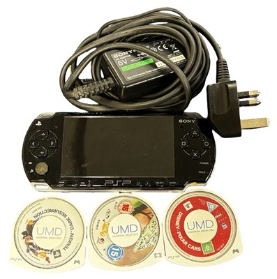 Lot 324 - A Sony PSP and adapter, together with 3 game...