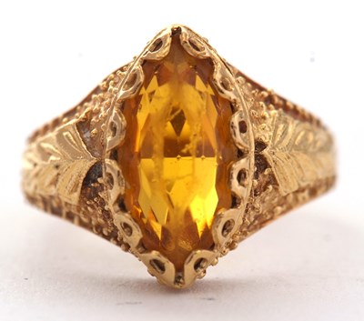 Lot 28 - An 18ct ring, set with a golden yellow paste...