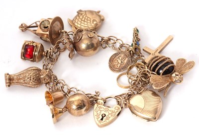 Lot 156 - A 9ct charm bracelet, with padlock clasp...