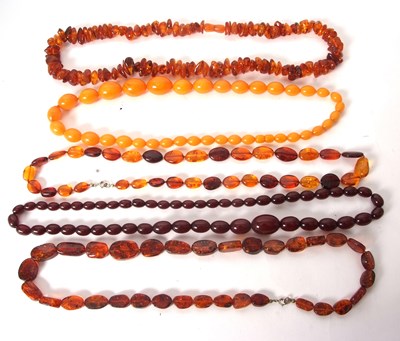 Lot 185 - A group of amber and amber simulant beads,...