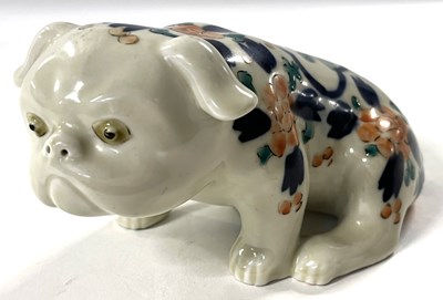 Lot 212 - A Japanese porcelain figure of a dog with...