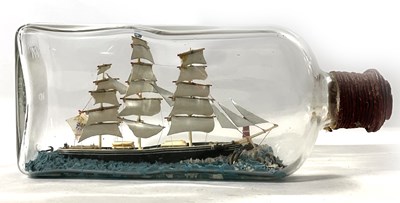 Lot 239 - A model of a three masted sailing ship in a...
