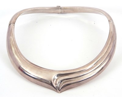 Lot 149 - A silver torque necklace, with tapered softly...