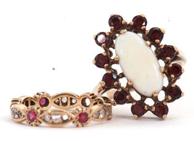 Lot 146 - Two garnet rings: the first set with an oval...
