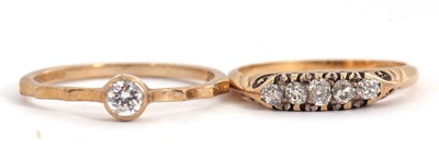 Lot 65 - Two gemset rings: the first set with five...