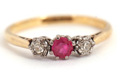Lot 64 - A ruby and diamond ring, the central round...