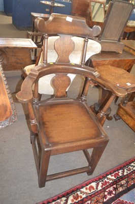 Lot 504 - An unusual George III oak high back armchair...