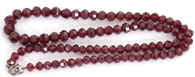 Lot 183 - A garnet bead necklace, the graduated round...
