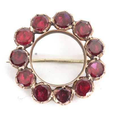 Lot 161 - A garnet wreath brooch, set with closed back...