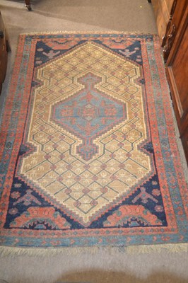 Lot 617 - A Middle Eastern wool floor rug with a large...