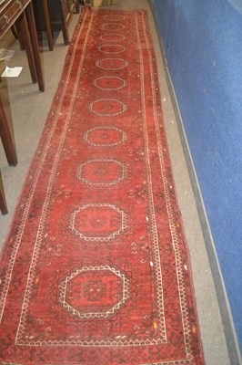 Lot 620 - A long Middle Eastern red runner carpet...