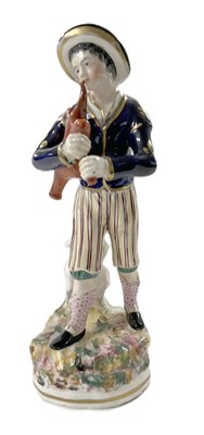 Lot 311 - 19th century porcelain model of a bag piper,...
