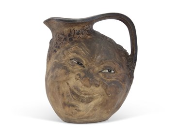 Lot 88 - A Martin ware face jug double sided with...