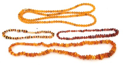 Lot 238 - A quantity of amber and simulated amber bead...