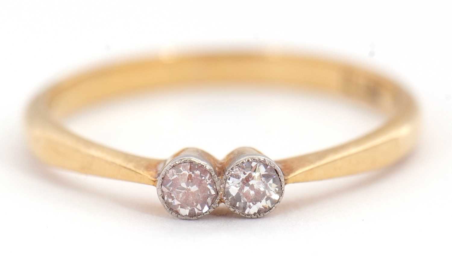 Lot 59 - A two stone diamond ring, set with two old...