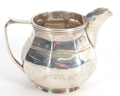 Lot 6 - A George V silver cream jug of plain octagonal...