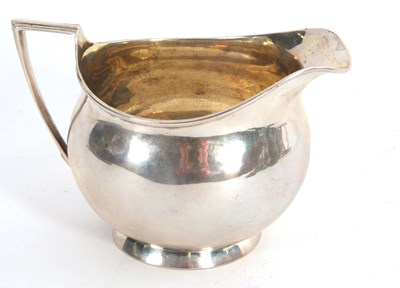 Lot 7 - A George III silver milk jug of plain helmet...