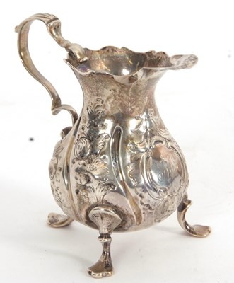 Lot 89 - A George III silver cream jug of baluster form...