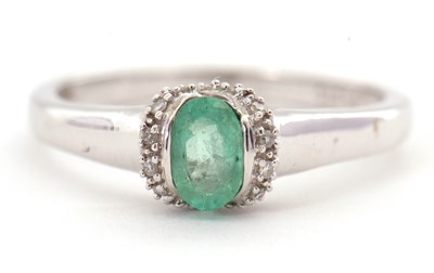Lot 95 - A 9ct emerald and diamond ring, the oval...