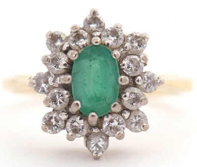 Lot 126 - An 18ct emerald and diamond ring, the oval...