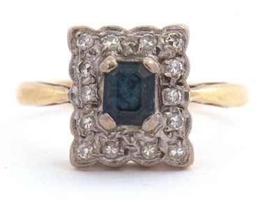 Lot 102 - A sapphire and diamond ring, the central...