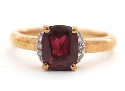 Lot 26 - A 9ct garnet and diamond ring, the modified...