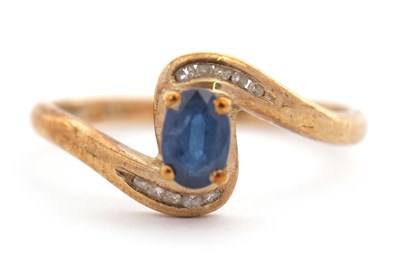 Lot 134 - A 9ct sapphire and diamond ring, set with a...