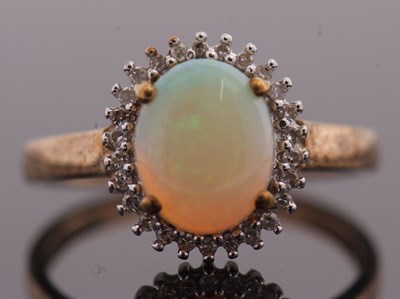 Lot 34 - A 9ct opal and diamond cluster ring, the oval...