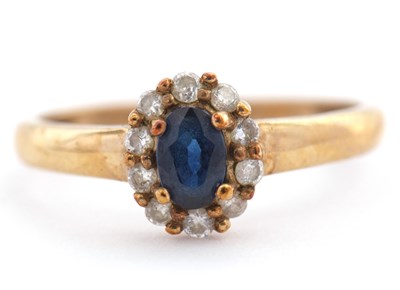 Lot 43 - A 9ct sapphire and diamond ring, with central...