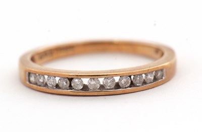 Lot 18 - A 9ct diamond half eternity ring, with channel...