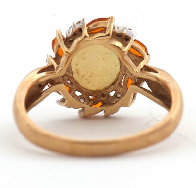 Lot 23 - A 9ct opal, fire opal and diamond ring, the...