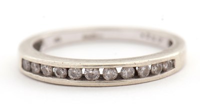 Lot 103 - A 9ct diamond half eternity ring, with channel...
