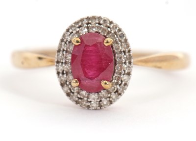 Lot 29 - A 9ct ruby and diamond ring, the oval ruby...