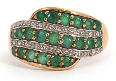 Lot 1 - A 9ct emerald and diamond ring, set with three...
