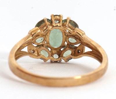 Lot 24 - A 9ct apatite and diamond cluster ring, with...