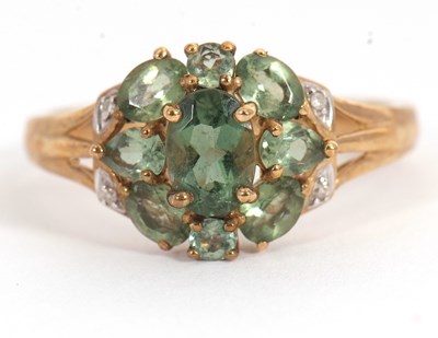 Lot 24 - A 9ct apatite and diamond cluster ring, with...