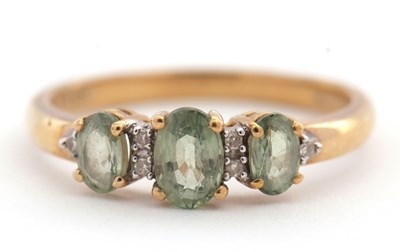 Lot 122 - A 9ct green stone and diamond ring with green...