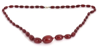 Lot 260 - A bakelite 'cherry amber' bead necklace, the...