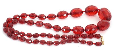 Lot 261 - A faceted 'cherry amber' bead necklace, with...