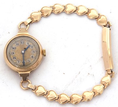 Lot 206 - A 9ct gold cased ladies watch on a rolled gold...