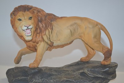 Lot 316 - A large Beswick model of a lion on simulated...